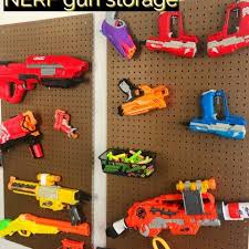 I made hangers for the guns from wire clothes hangers. Diy Pegboard Nerf Gun Storage Moments With Mandi