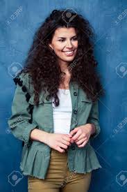 If you're just looking to get some color in for your halloween fun, coloring a few strips. Young Pretty Woman With Curly Brunette Hair Posing Cheerful On Blue Background Lifestyle People Concept Stock Photo Picture And Royalty Free Image Image 149887209