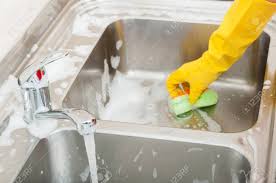 householder cleaning the kitchen sink