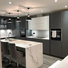 Even though the color is bold, the simplicity of the kitchen design—including the open wood shelving—stops it from becoming overpowering. Next125 Kitchen With Stunning Dekton Aura 15 By Consentino Consentinouk Kitchendesign Next125 In 2021 Kitchen Inspiration Design Kitchen Inspirations Kitchen Design