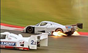 Mercedes Benz Sauber C11 Spitting Flames Beside A Jaguar Xjr14 Sports Car Racing Lemans Car Classic Racing Cars