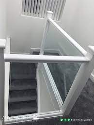 Winding modern staircase with glass railing from upper landing in 2 story foyer in a modern home. Pin On Painted Stained Staircases