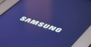 The samsung logo is pictured as a woman checks the phone during the annual web summit technology conference in lisbon, portugal on november 6, 2019. How To Fix Android Won T Turn On Or Stuck On Samsung Logo Screen Technobezz