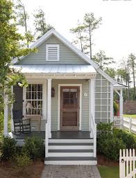 Cavepool grey wood paint with tones of blue and touches of green. What A Dreamy Little Cottage Love That Light Gray Green Color With The Wood Door House Paint Exterior Cottage Exterior Exterior Paint Colors For House