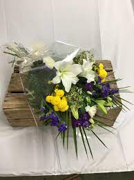 Single burning yellow candle in front of a globe next to red and yellow roses against dark background, concept of global disasters and deaths. Purple Yellow Funeral Flowers In Cellophane Katherine S Florists