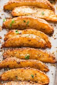 Crispy Baked Garlic Parmesan Potato Wedges On A Baking Tray Potato Side Dishes Baked Potato Wedges Recipe Parmesan Baked Potatoes