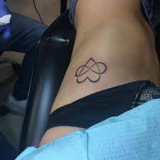 Infinity tattoos have been around for a while, but their meaning & symbolism have grown significantly as new generations take hold. Side Tattoo Of A Infinity Heart Tattoo On Crystal