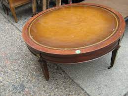 This coffee table features a wooden top and metallic legs. Uhuru Furniture Collectibles Leather Top Round Coffee Table 45 Reduced Sold