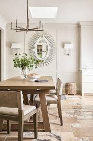 Choose linen material to give a comfortable and clean atmosphere. White Oval Sunburst Mirror In Dining Space Transitional Dining Room