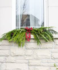 Using hot glue to attach christmas lights to brick & stucco. A Garland Hack And How To Make And Hang Window Christmas Swag