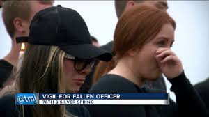 'He didn’t give his life in vain': Vigil for fallen officer draws large  crowd