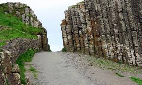 THE GIANTS GATE The Giant's Causeway is an area of about 40,000  interlocking basalt columns, the result of an ancient volcanic eruption.It  is located in County Antrim on the north coast of