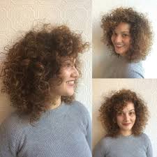 Side swept bangs with messy bun. Voluminous Tousled Curly Bob With Curly Side Swept Bangs And Sun Kissed Caramel Ombre The Latest Hairstyles For Men And Women 2020 Hairstyleology