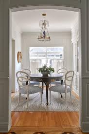 Meg says this dining room is used more in the winter when one can't eat outside, so she chose a cozy color palette. Round Gold And Black Chinoiserie Dining Table Transitional Dining Room