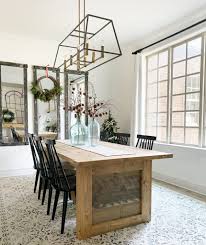 Sculpted twin pedestals support the rectangular top of this rustic dining table. Diy Farmhouse Panel Dining Table Shanty 2 Chic
