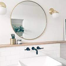 Check out the kohler purist sconces in a vibrant brushed nickel finish. Reflect Light And Style With Our Round Classic Framed Mirror Seen Here In Sophiecarpenter S Bathro Round Mirror Bathroom Bathroom Mirrors Diy Bathroom Mirror