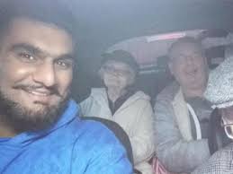 Young Muslim volunteers transport group of elderly people to Christmas  lunch in 'wonderful' act of charity