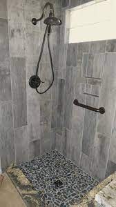 Browse bathroom designs and decorating ideas. Wall Is Cellar Char 8x36 Shower Floor Is Black Pearl Flat Pebbles Shower Tile Shower Floor Shower Wall
