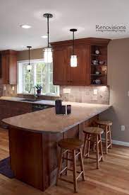 The kitchen peninsula and island are both the addition of a countertop in the kitchen. Kitchen Remodel By Renovisions Cherry Cabinets Shaker Cabinets Under Cabinet Lights Tuscan Cla Kitchen Remodel Small Cherry Cabinets Kitchen Kitchen Layout
