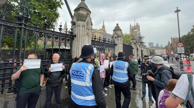 Anti-monarchy protesters hold blank signs outside Parliament - Big Issue