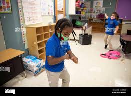 Austin, Texas, USA. 6th Oct, 2020. Under the careful watch of third grade  teacher JEANINE DOYLE and with plenty of PPE ready, in-person learning  takes off once again during the second day
