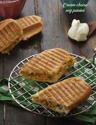 Place cheese, grilled mushrooms and onions, fresh spinach, tomatoes, and avocado on the bread. Cream Cheese Veg Panini Recipe