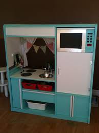 kids play kitchen made from a tv stand