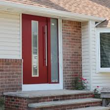 The red front door has rectangular panels with a golden colored handle and locks. Entry Door Madrid Ville Doors Wooden Aluminum Stainless Steel