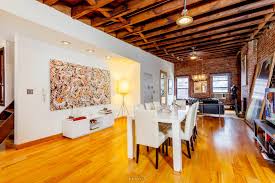 An exposed brick wall is the cornerstone behind every industrial living room design. A 32 Foot Long Living Room With Exposed Brick Dominates This Hell S Kitchen Loft Rental 6sqft