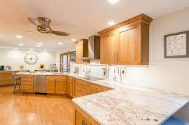 The depth and movement of the natural stone complements the tone and texture of wood cabinets, while a range of white hues contrast the cabinets to brighten and visually expand the space. Cherry Kitchen Cherry Wood Kitchen Cabinets Cherry Cabinets Kitchen Kitchen Remodel