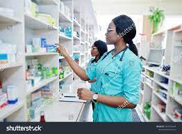 Two African American Pharmacist Working In Drugstore At Hospital Pharmacy African Healthcare Ad Affiliate Phar Hospital Pharmacy Pharmacist Health Care