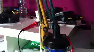 Homemade electric fence tester constructed from a surplus spark plug, electrical fence wire, rubber hose, plastic handle, and insulating tape. Electric Fence Generator Homemade Youtube