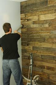 How To Diy A Pallet Accent Wall Bower Power Pallet Accent Wall Home Diy Home Projects