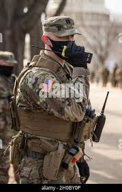 U.S. Army Capt. Donald Walter, commander, 253rd Engineer Company (Sapper),  Maryland National Guard, responds to a message over the radio during the  59th Presidential Inauguration, Jan. 20, 2021, Washington, D.C. At least