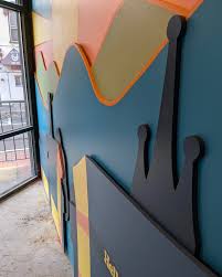 Installation of this die cut mural at Hello, Hi today with help from  @at__________space. Paintings by @baileymonty.vt. Cutouts in MDF made