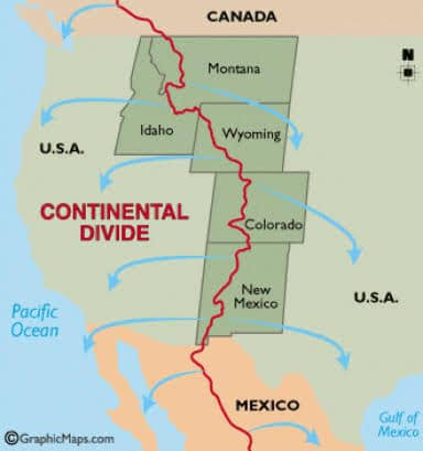 USA - The Continental Divide. A continental divide is a boundary line that  indicates where precipitation will drain to different bays, gulfs, seas, or  oceans. Running mostly along the crests of mountain