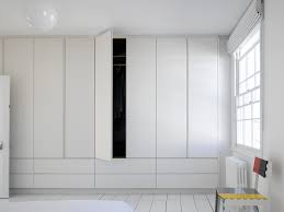 A spacious wardrobe with drawers hidden inside, thanks to which from the outside you can see just its tall, elegant fronts. Full Height Simple White Wardrobes Drawers From Roundhouse Design