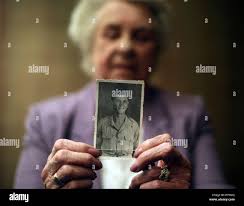 Alma Williams holds a photograph of her late brother Lance Corporal (LCpl)  Ronald George Blackham at a press conference at the Hotel NH Napoli  Ambassador, who died as he stormed a German-held
