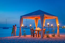 Pampered In Paradise Offers Incomparable Romantic With The Sea At Your Feet Tiki Torches Creating A Glow On Aruba Resorts Palm Beach Aruba Hotels Aruba Hotels