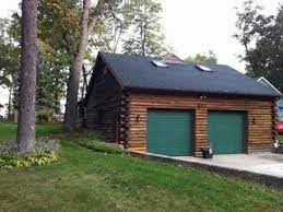 Log garages have better insulation and can last longer than traditional builds. Exterior Staining Two Car Log Cabin Garage Klassisch Garage Chicago Von Five Star Painting Of Yorkville Houzz