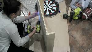 The cork backing is relatively easy to penetrate and only a little force should be used. Diy Dartboard Cabinet The Inspired Workshop