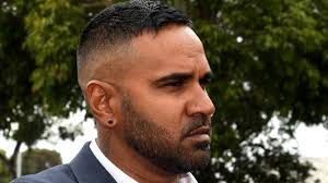 Former Essendon player Andrew Lovett bashed a motorist