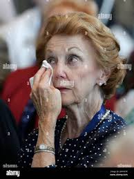 Violet Parks wipes a tear as she watches a video after her husband, Raymond  Parks, was announced as one of five inductees for the 2017 class of the  NASCAR Hall of Fame