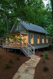 The porch has a wood ceiling and rustic shutter. Rustic Exterior Design Ideas Trendecors