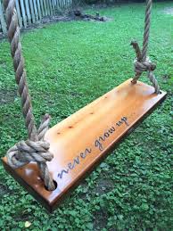 Never Grow Up Wooden Rope Swing Natural Wood Tree Swing Etsy In 2020 Outdoor Wooden Swing Wood Tree Swing Tree Swing