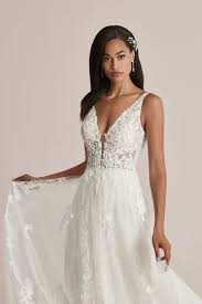 A cute young woman in a hat and a yellow dress with a plunging neckline is. Plunging Necklines Wedding Dresses Justin Alexander