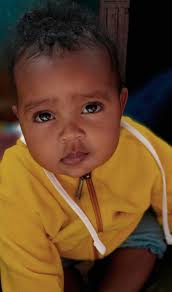 Lying Child in Purple Clothes · Free Stock Photo