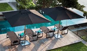 A dining table poolside is ideal for a relaxing eating experience, especially with tiki torches. The Top Outdoor Furniture Brands For Summer 2018 Mohd Design Magazine