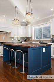 At cabinets.com, we offer a variety of gray painted cabinet doors to create the right look for your dream kitchen, no matter your style. This Bright White Kitchen Has White Cabinets And Grey Quartz Counter With A Grey Gl Blue Kitchen Island Butcher Block Island Kitchen Navy Blue Kitchen Cabinets