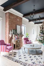 Gorgeous custom wood framed fireplace next to a shiny black grand piano. Living Room Black Ceiling Novocom Top
